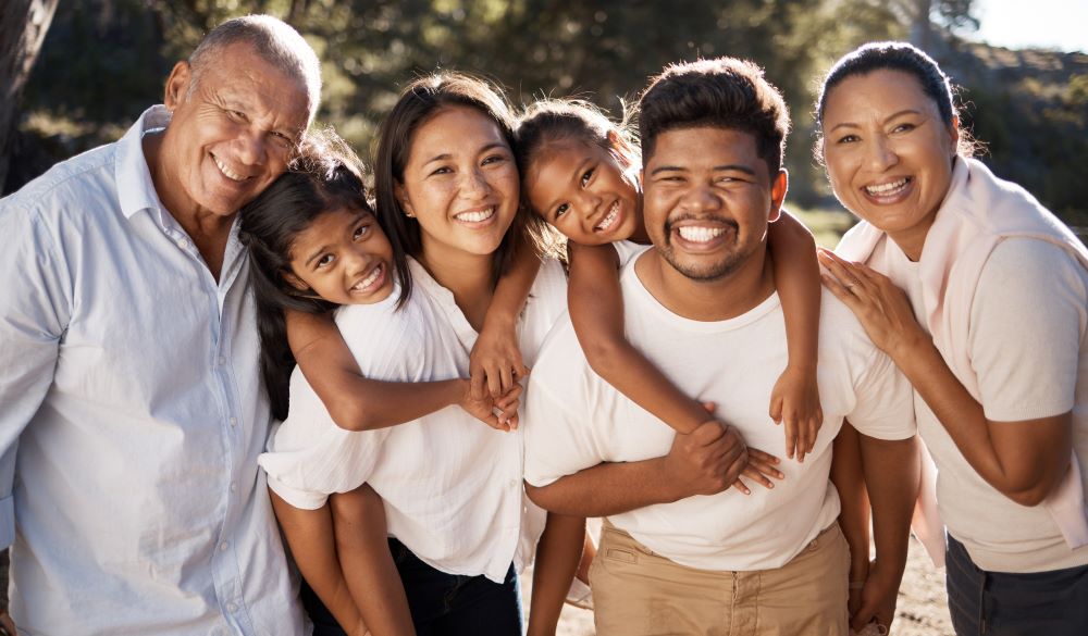 Intergenerational family smiling at the camera 