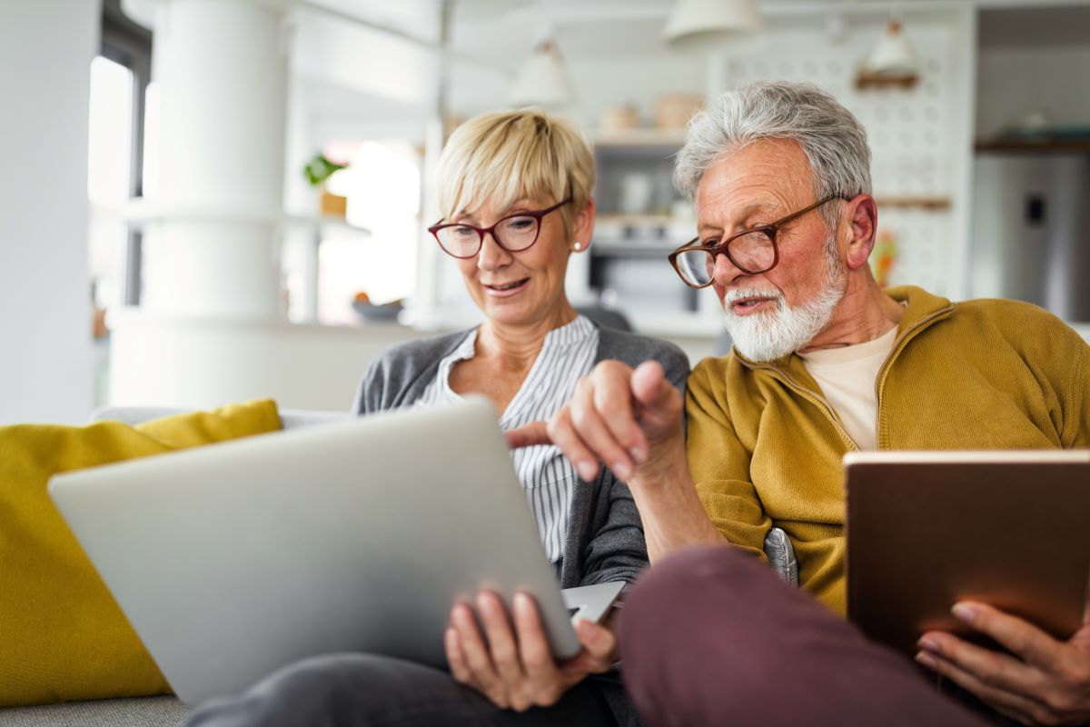 Senior couple reviewing something on their laptop